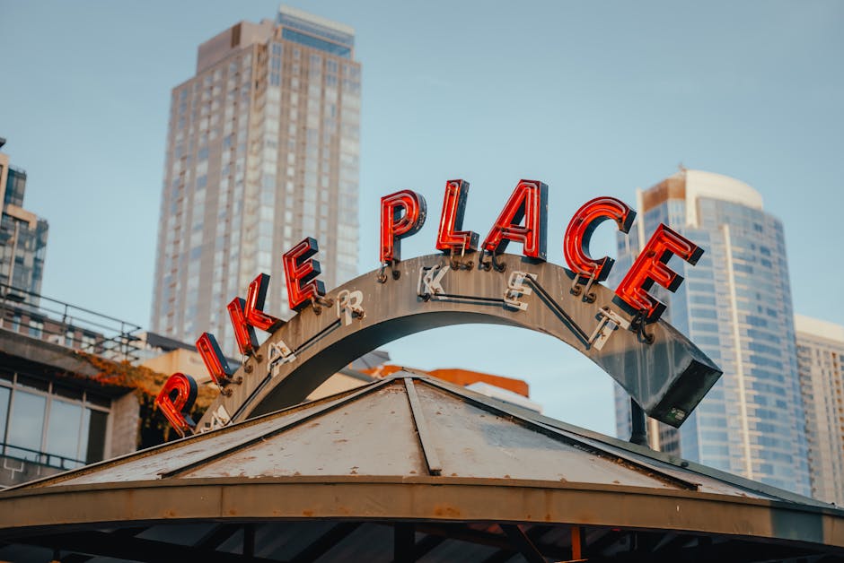 Pike Place Market entrance sign in downtown Seattle with street scene